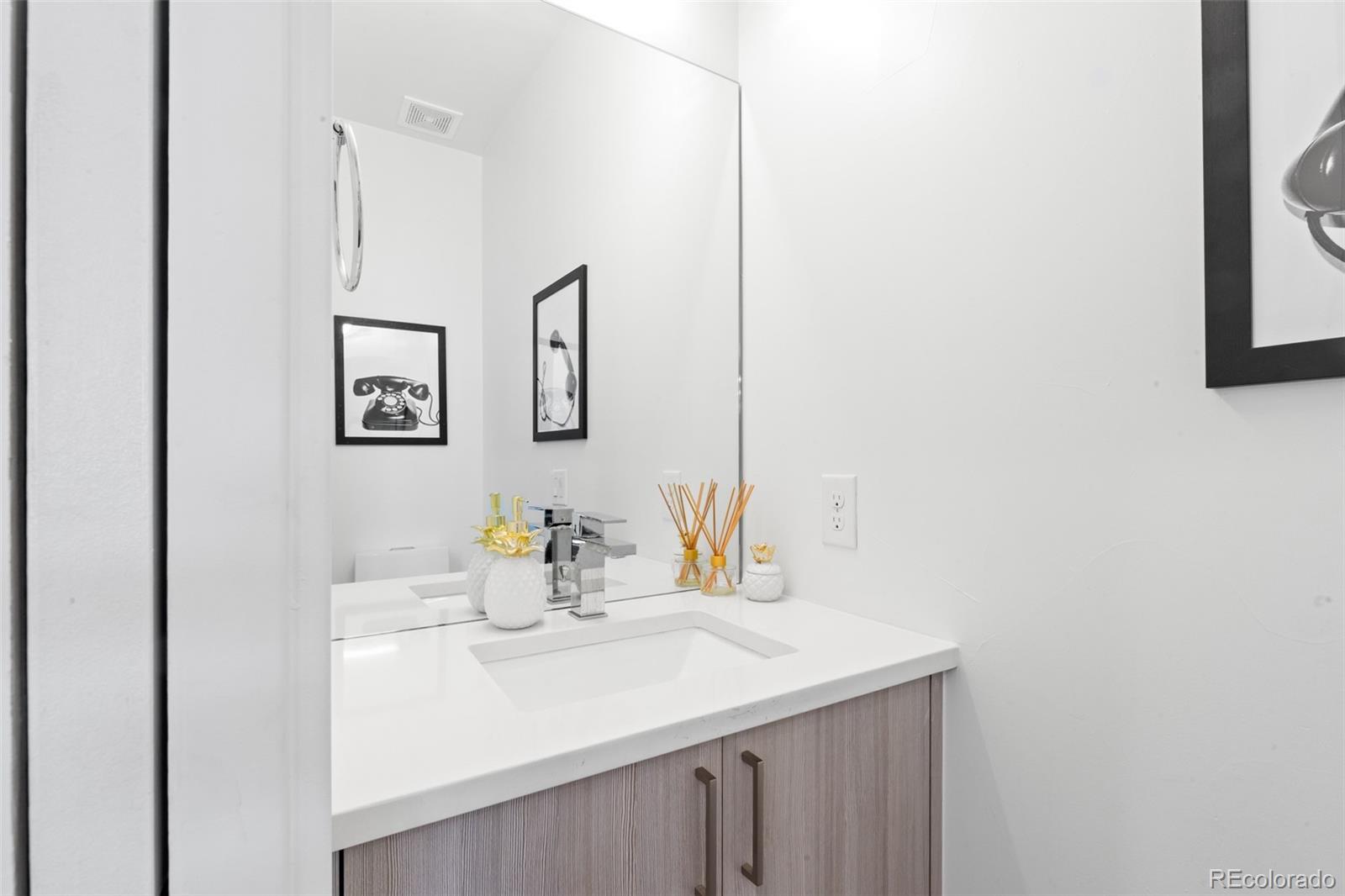 1608 Irving Street Denver, CO 80204 - Photo 7 of 37 a bathroom with a sink and a mirror