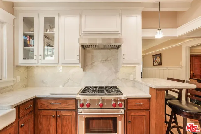 a kitchen with granite countertop a stove and a sink