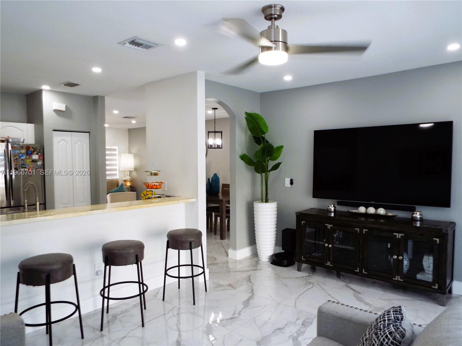 21470 Southwest 85th Path Cutler Bay, FL 33189 - Photo 16 of 50 a living room with furniture and a flat screen tv