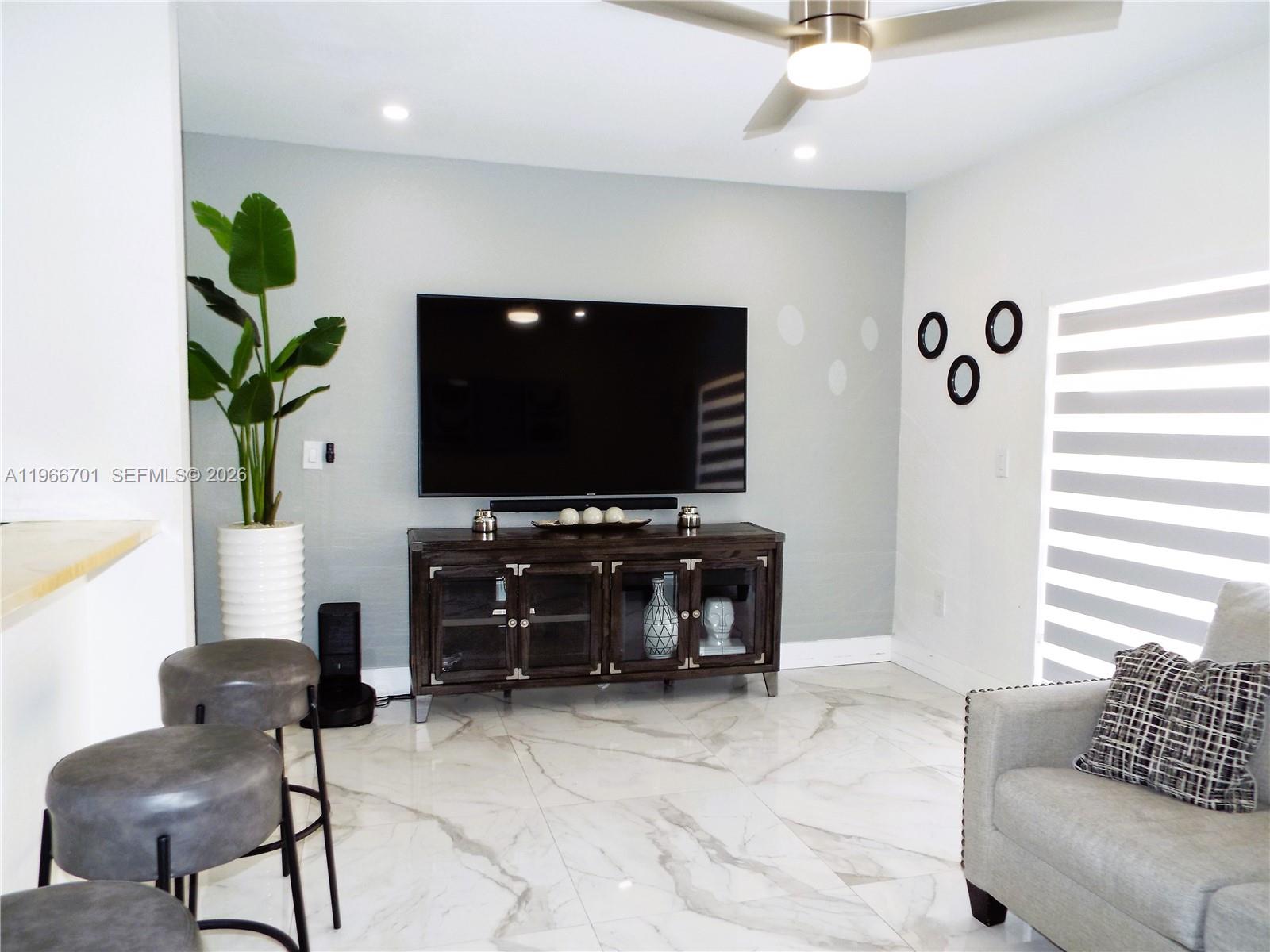 21470 Southwest 85th Path Cutler Bay, FL 33189 - Photo 17 of 50 a living room with furniture and a flat screen tv