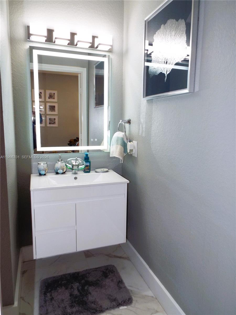 21470 Southwest 85th Path Cutler Bay, FL 33189 - Photo 19 of 50 a bathroom with a sink and a mirror