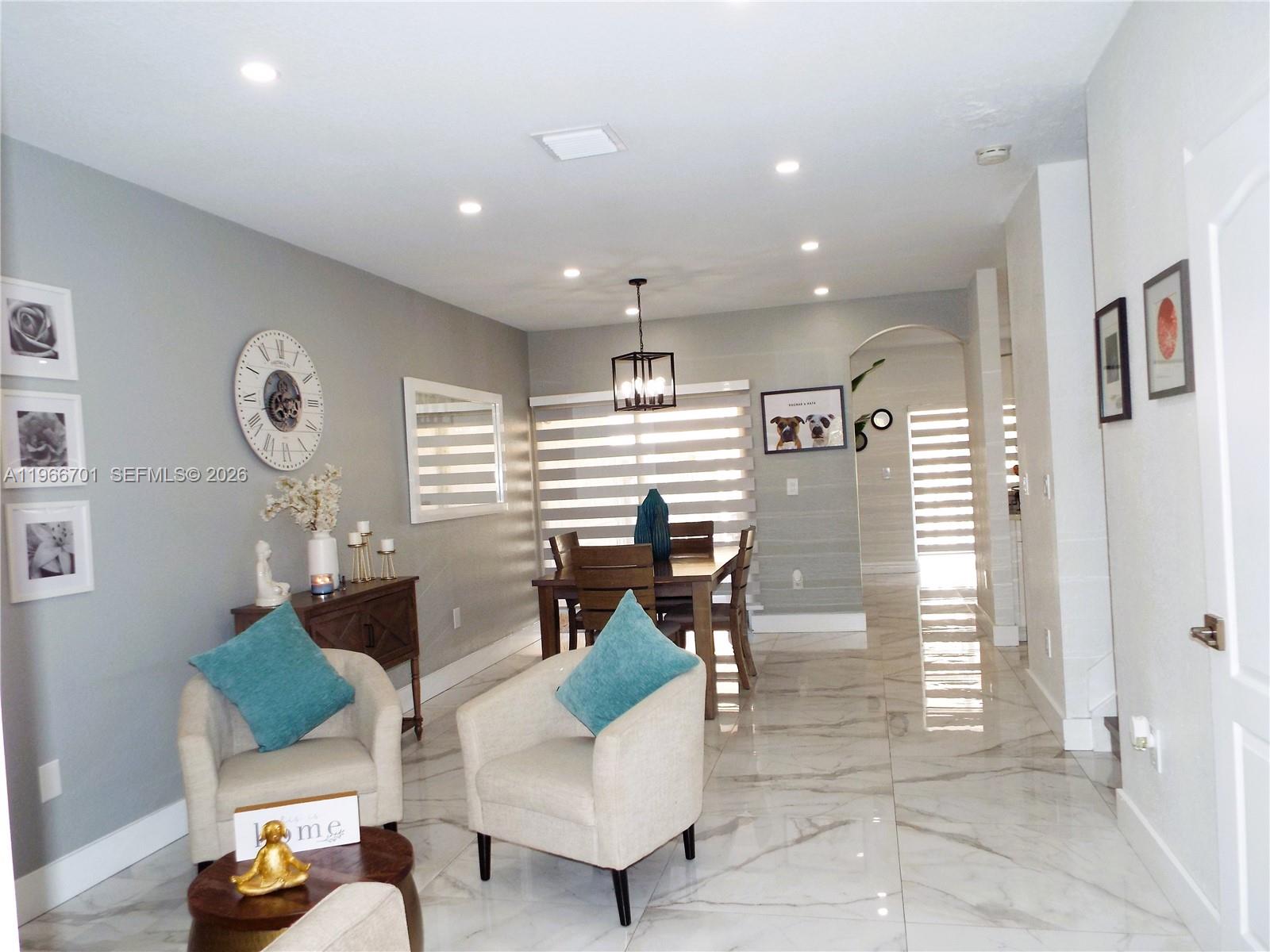 21470 Southwest 85th Path Cutler Bay, FL 33189 - Photo 2 of 50 a very nice looking living room with dining room and windows