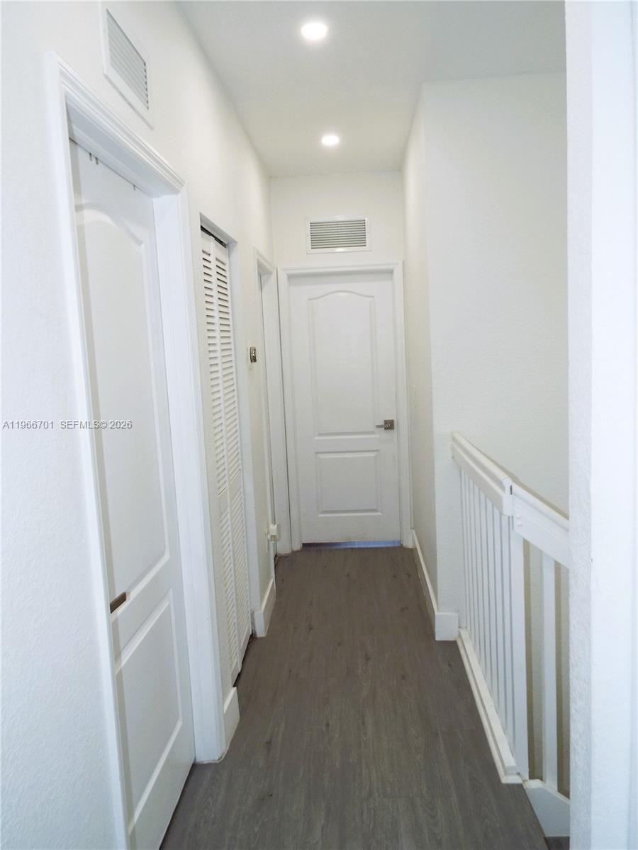 21470 Southwest 85th Path Cutler Bay, FL 33189 - Photo 22 of 50 a view of a hallway with wooden floor