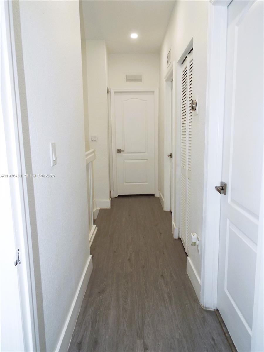 21470 Southwest 85th Path Cutler Bay, FL 33189 - Photo 23 of 50 a view of a hallway with a wooden floor
