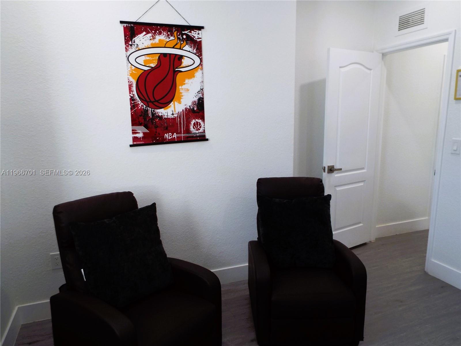 21470 Southwest 85th Path Cutler Bay, FL 33189 - Photo 28 of 50 a close up of a chair with paintings on the wall