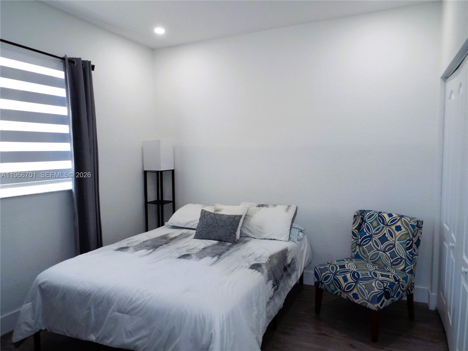 21470 Southwest 85th Path Cutler Bay, FL 33189 - Photo 29 of 50 a bedroom with a bed and a window