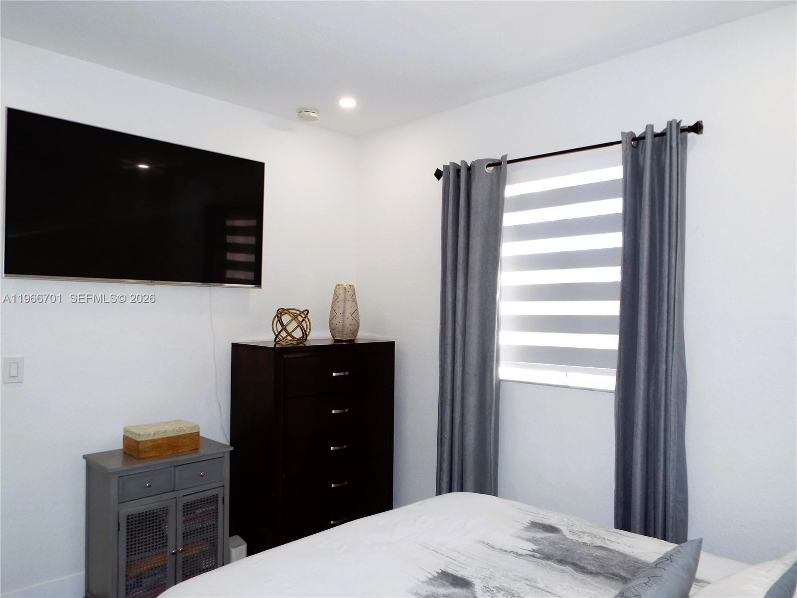 21470 Southwest 85th Path Cutler Bay, FL 33189 - Photo 32 of 50 a bedroom with a bed and a flat screen tv