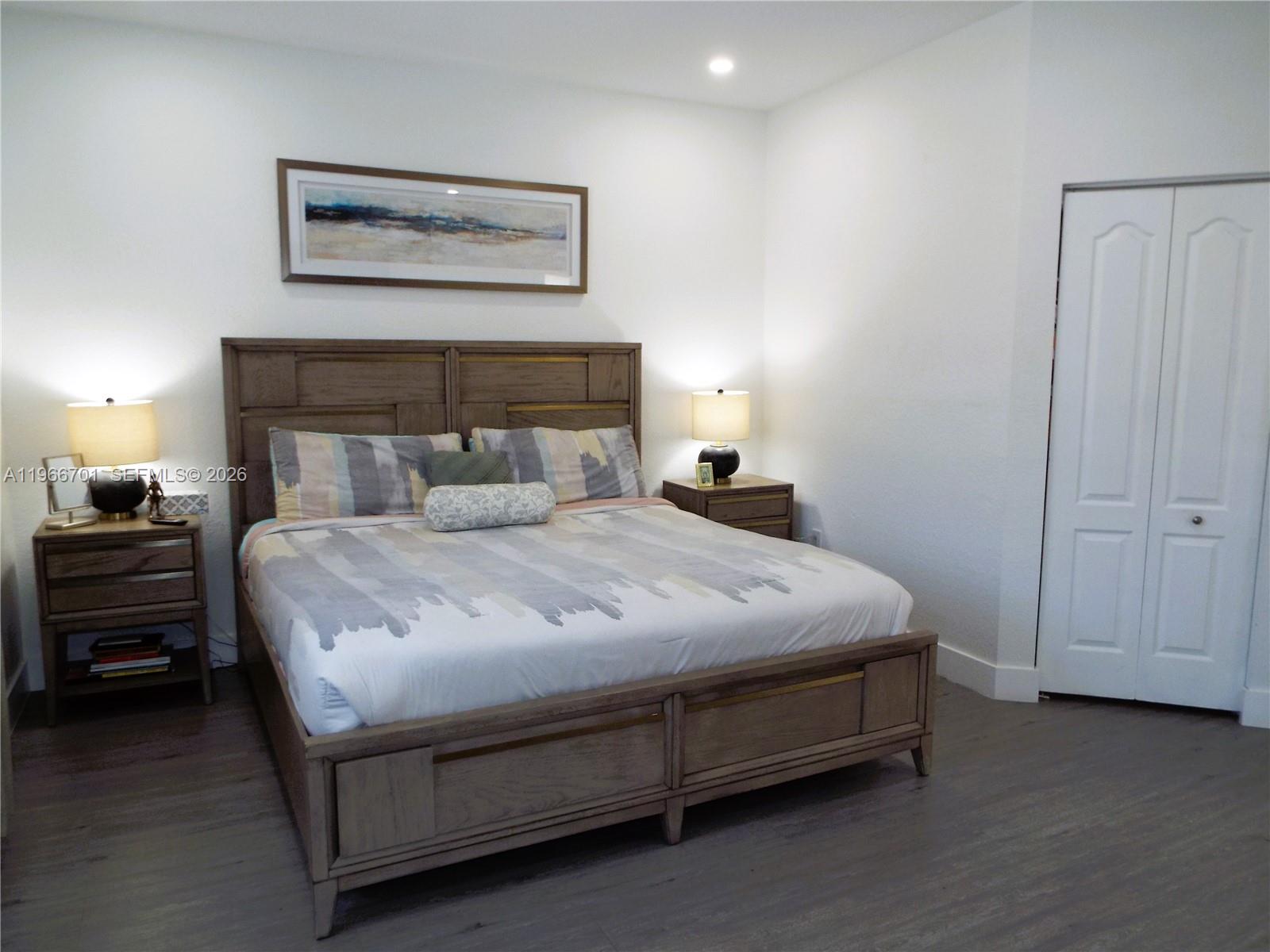 21470 Southwest 85th Path Cutler Bay, FL 33189 - Photo 37 of 50 a bedroom with a bed and a night stand