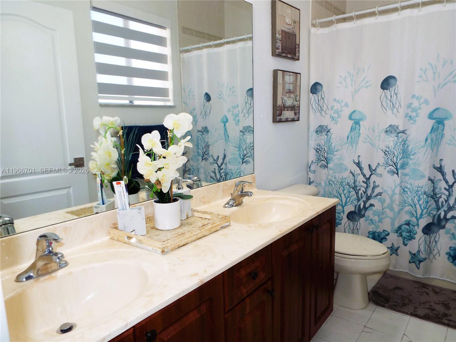 21470 Southwest 85th Path Cutler Bay, FL 33189 - Photo 41 of 50 a bathroom with a sink and a mirror