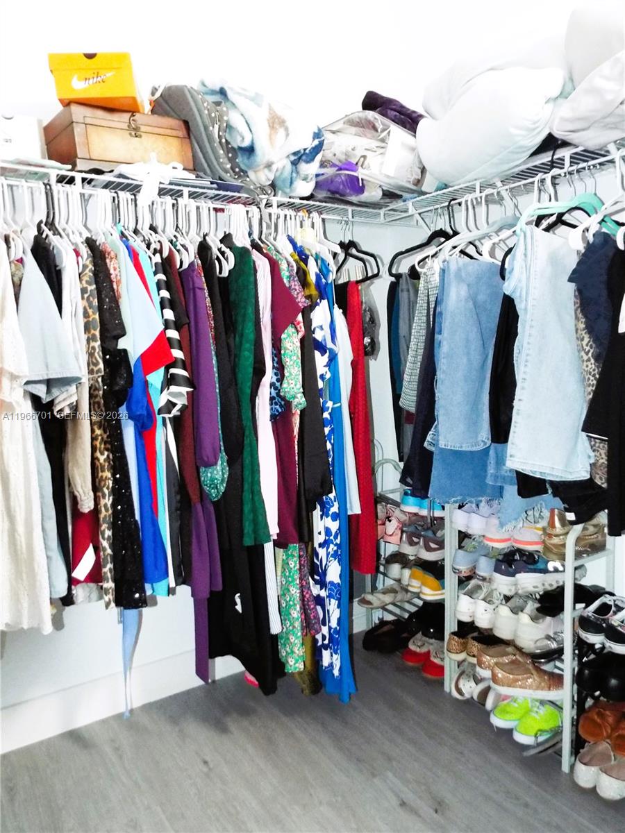 21470 Southwest 85th Path Cutler Bay, FL 33189 - Photo 44 of 50 a view of walk in closet with clothes and shoes