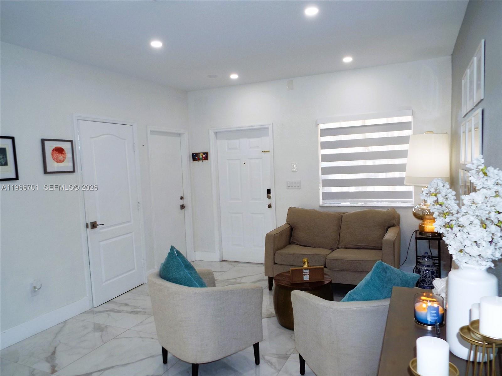 21470 Southwest 85th Path Cutler Bay, FL 33189 - Photo 5 of 50 a living room with furniture and a potted plant