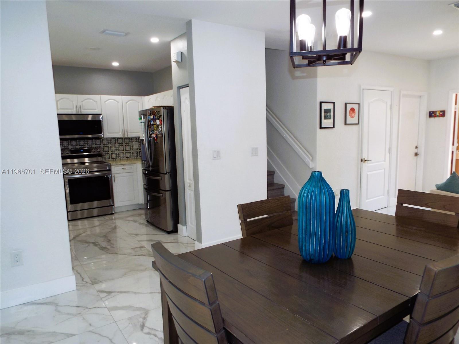 21470 Southwest 85th Path Cutler Bay, FL 33189 - Photo 10 of 50 a kitchen with stainless steel appliances granite countertop a refrigerator and a stove top oven