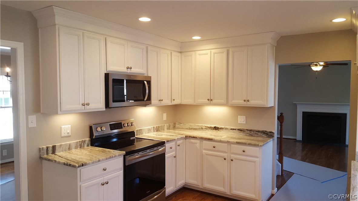 1613 Wilson Wood Road Midlothian, VA 23114 - Photo 12 of 37 a kitchen with granite countertop white cabinets and stainless steel appliances