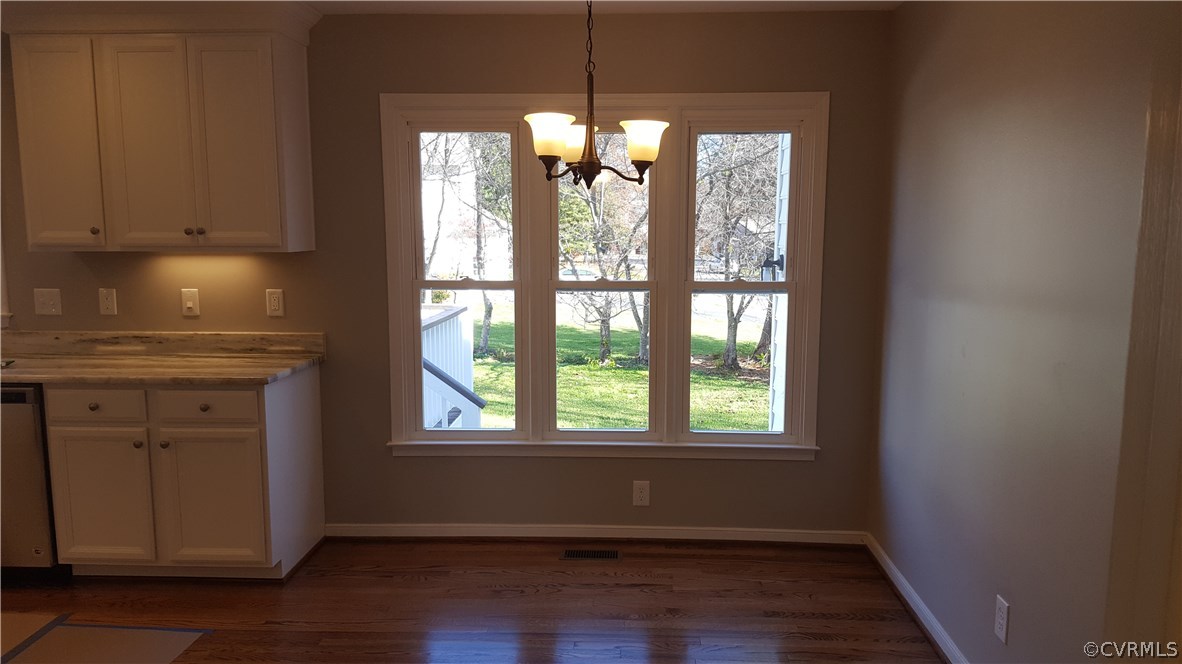 1613 Wilson Wood Road Midlothian, VA 23114 - Photo 14 of 37 a view of an empty room with wooden floor and a window