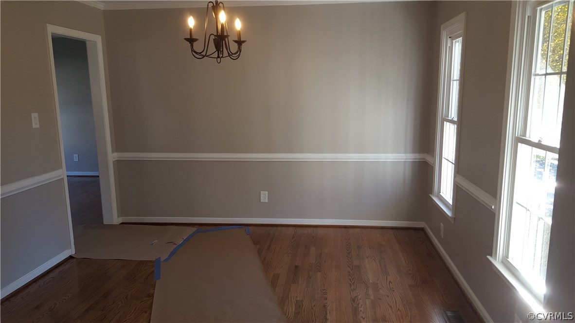 1613 Wilson Wood Road Midlothian, VA 23114 - Photo 4 of 37 an empty room with wooden floor and windows