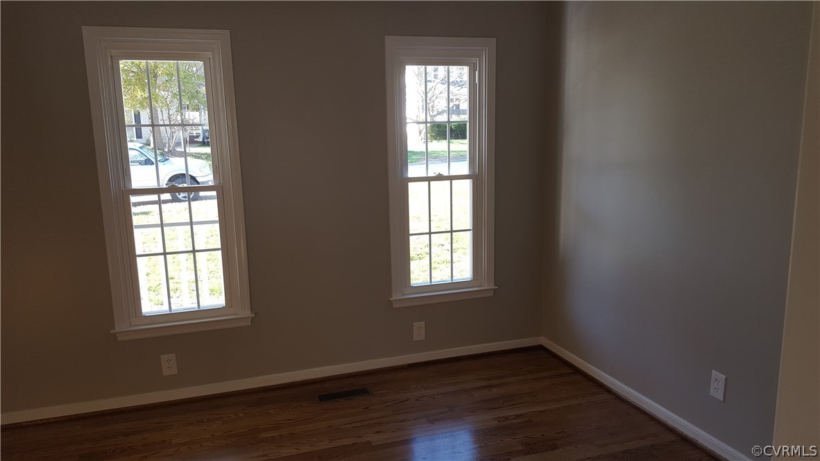 1613 Wilson Wood Road Midlothian, VA 23114 - Photo 6 of 37 an empty room with wooden floor and windows