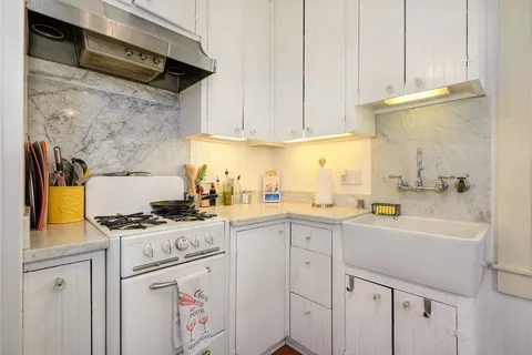 a living room with stainless steel appliances kitchen island granite countertop furniture and a kitchen view