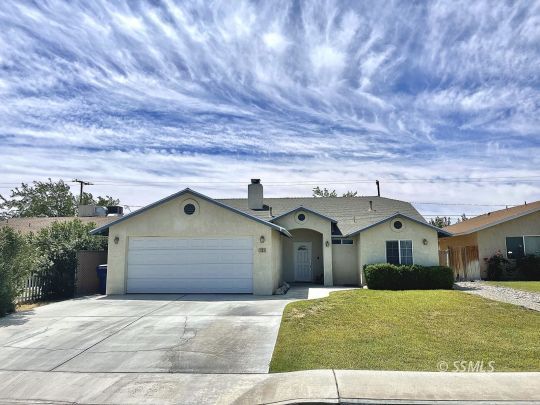 1133 West Benson Avenue Ridgecrest, CA 93555 - Photo 1 of 34 a front view of a house with a garden and garage