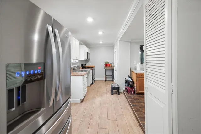 a view of a kitchen with a sink and a refrigerator