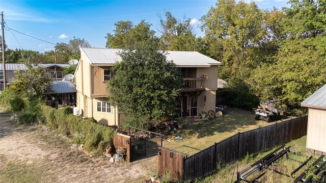 a view of a house with yard and sitting area