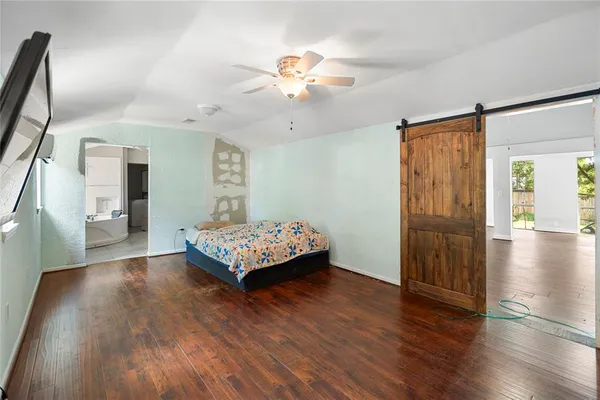 a bedroom with furniture and a flat screen tv