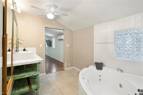 a view of washer and dryer with bathtub in a room