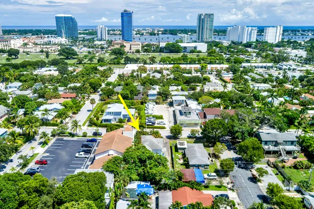an aerial view of residential houses with outdoor space and trees all around