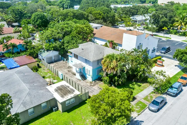 an aerial view of a house with a garden and lake view