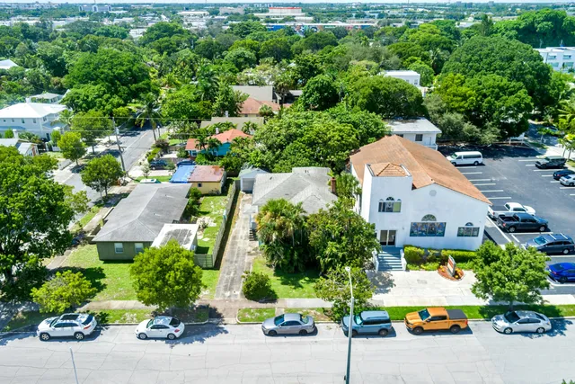 an aerial view of multiple houses with yard
