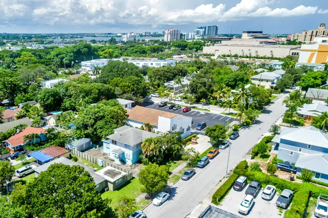 an aerial view of residential houses with outdoor space and swimming pool