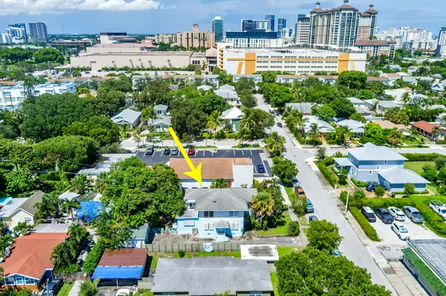 an aerial view of residential houses with yard and lake view