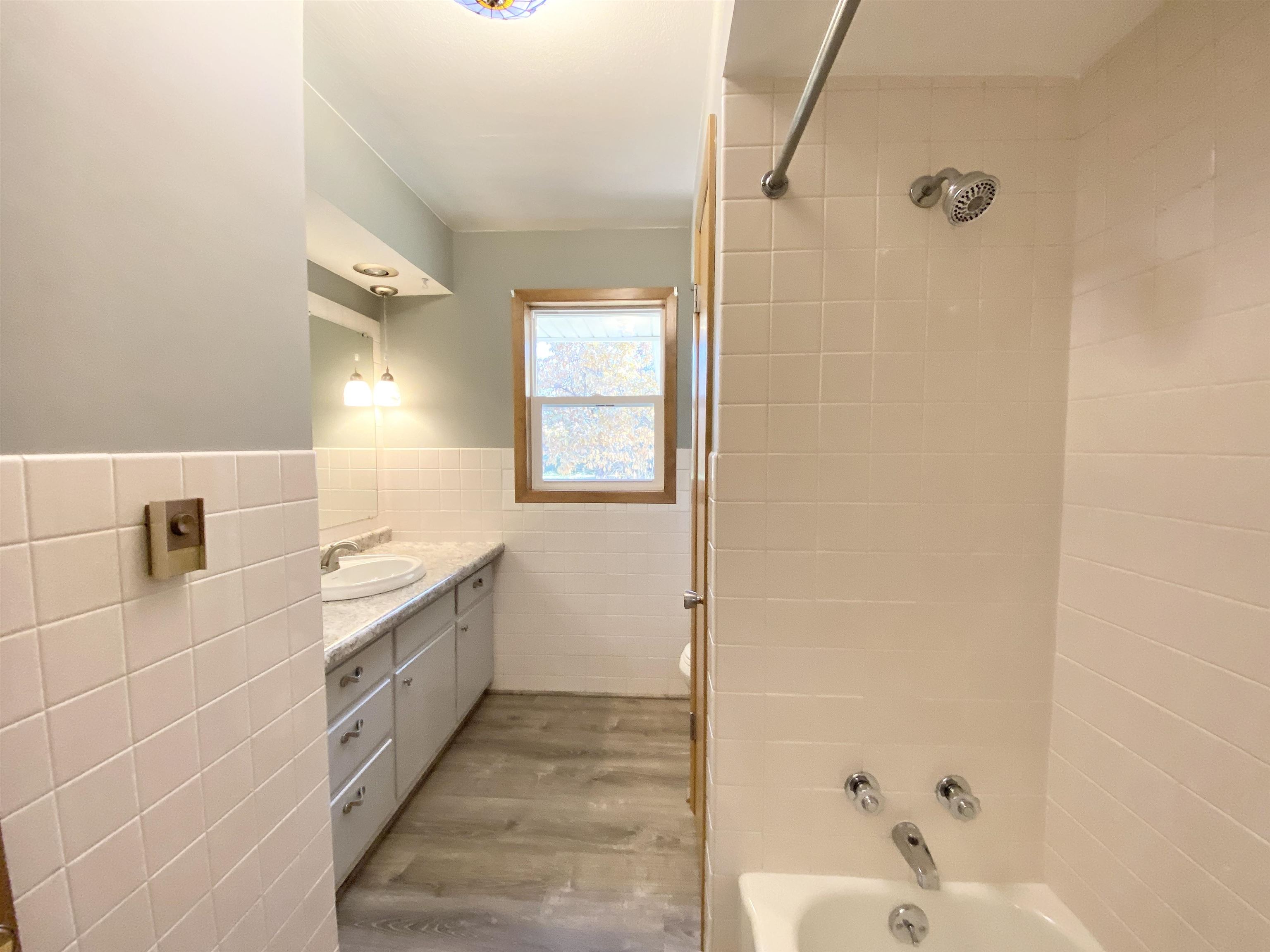 10414 Beaver Valley Road Belvidere, IL 61008 - Photo 10 of 20 a bathroom with a granite countertop sink a mirror and a bathtub