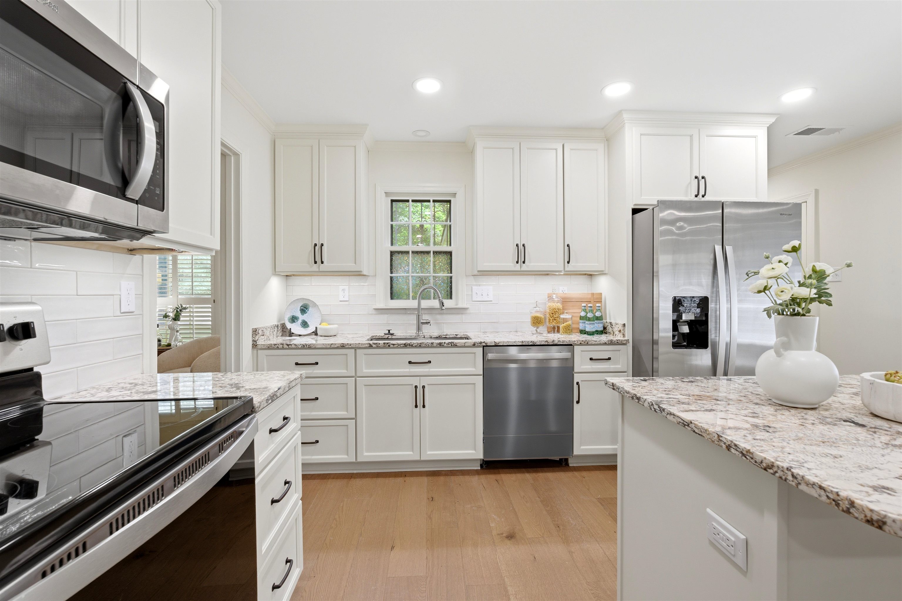 1984 Allenby Road Germantown, TN 38139 - Photo 14 of 37 Kitchen with recessed lighting, light wood-finish flooring, white shaker cabinetry, stainless steel appliances, and light-toned patterned countertops