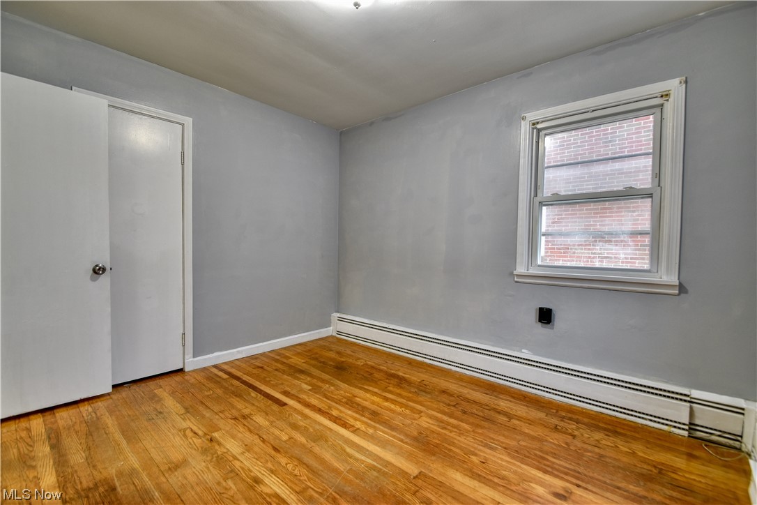 980 Reeve Road Elyria, OH 44035 - Photo 24 of 24 Spare room featuring baseboard heating and light wood-type flooring