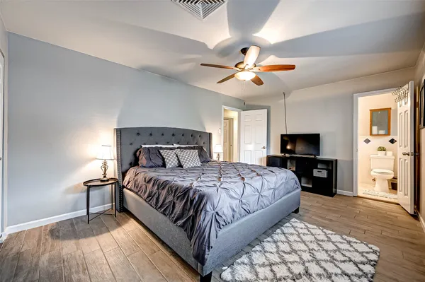 a bedroom with a bed and a painting on the wall