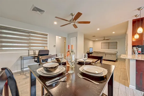 a dining room with furniture and a window