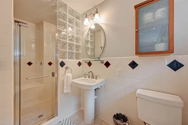 a bathroom with a sink mirror toilet and shower