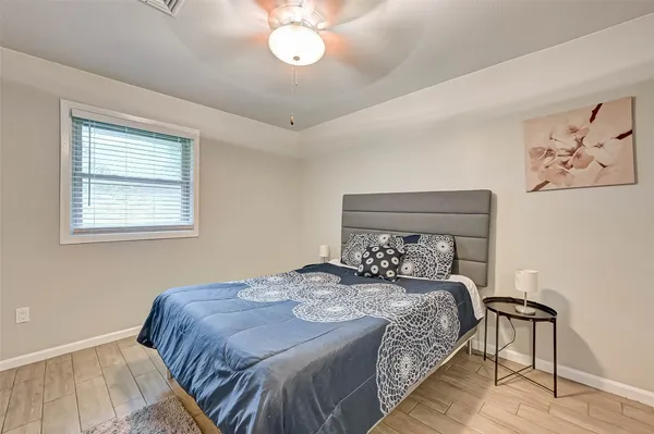 a bedroom with a bed and a painting on the wall
