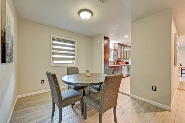 a view of a dining room with furniture and window
