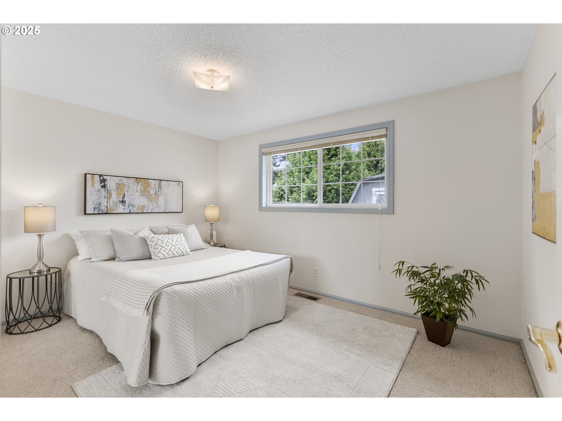 2055 Ridgeway Drive Eugene, OR 97401 - Photo 13 of 48 a bedroom with a bed and a potted plant