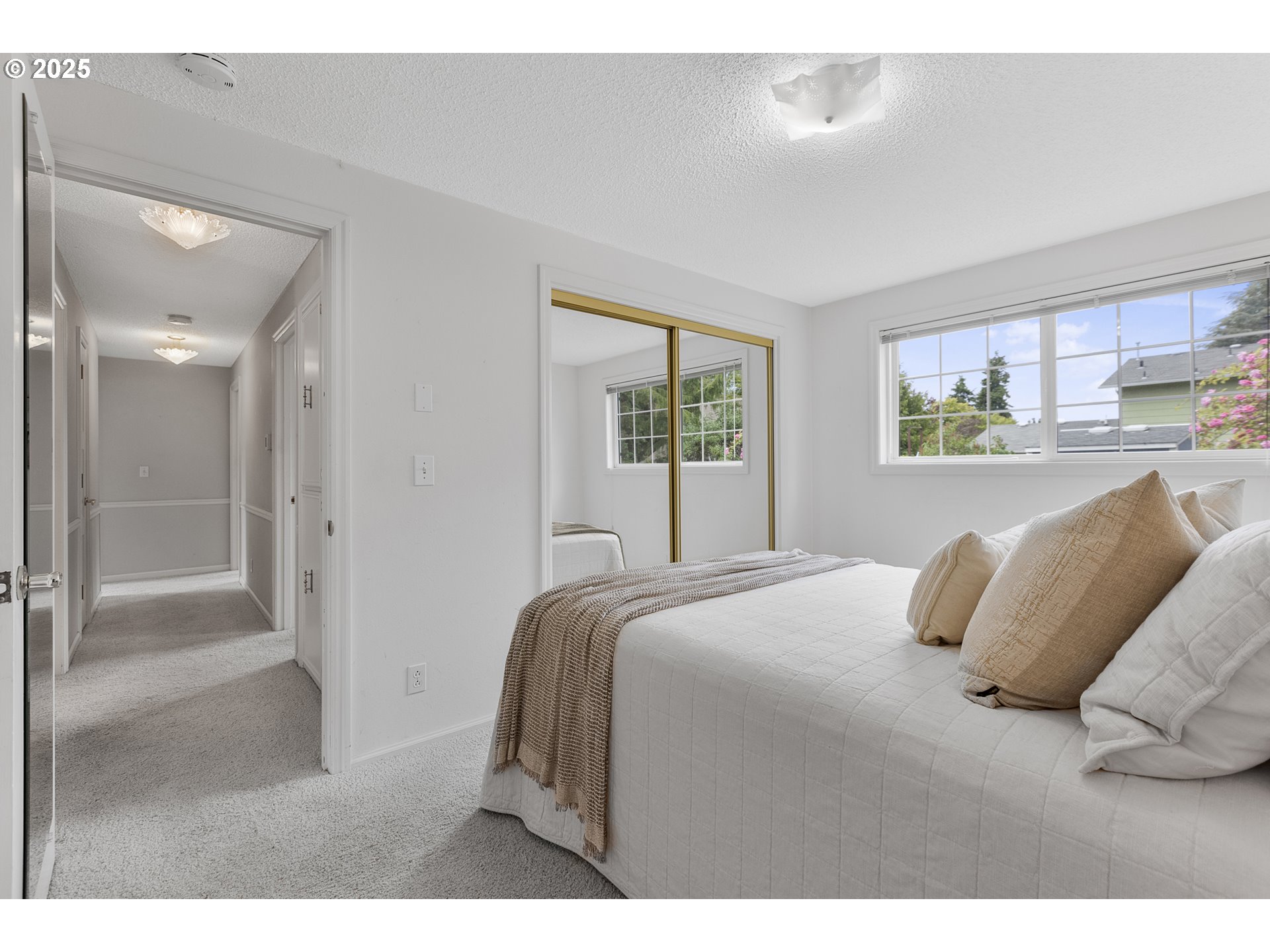 2055 Ridgeway Drive Eugene, OR 97401 - Photo 20 of 48 a bedroom with a bed and glass windows