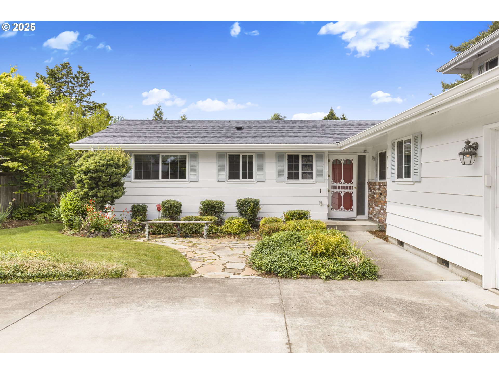 2055 Ridgeway Drive Eugene, OR 97401 - Photo 2 of 48 a front view of a house with garden