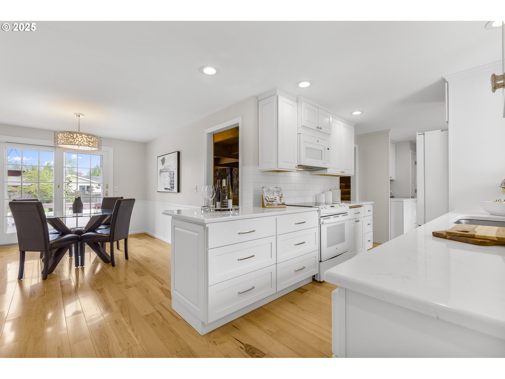 2055 Ridgeway Drive Eugene, OR 97401 - Photo 3 of 48 a kitchen with white cabinets and chairs