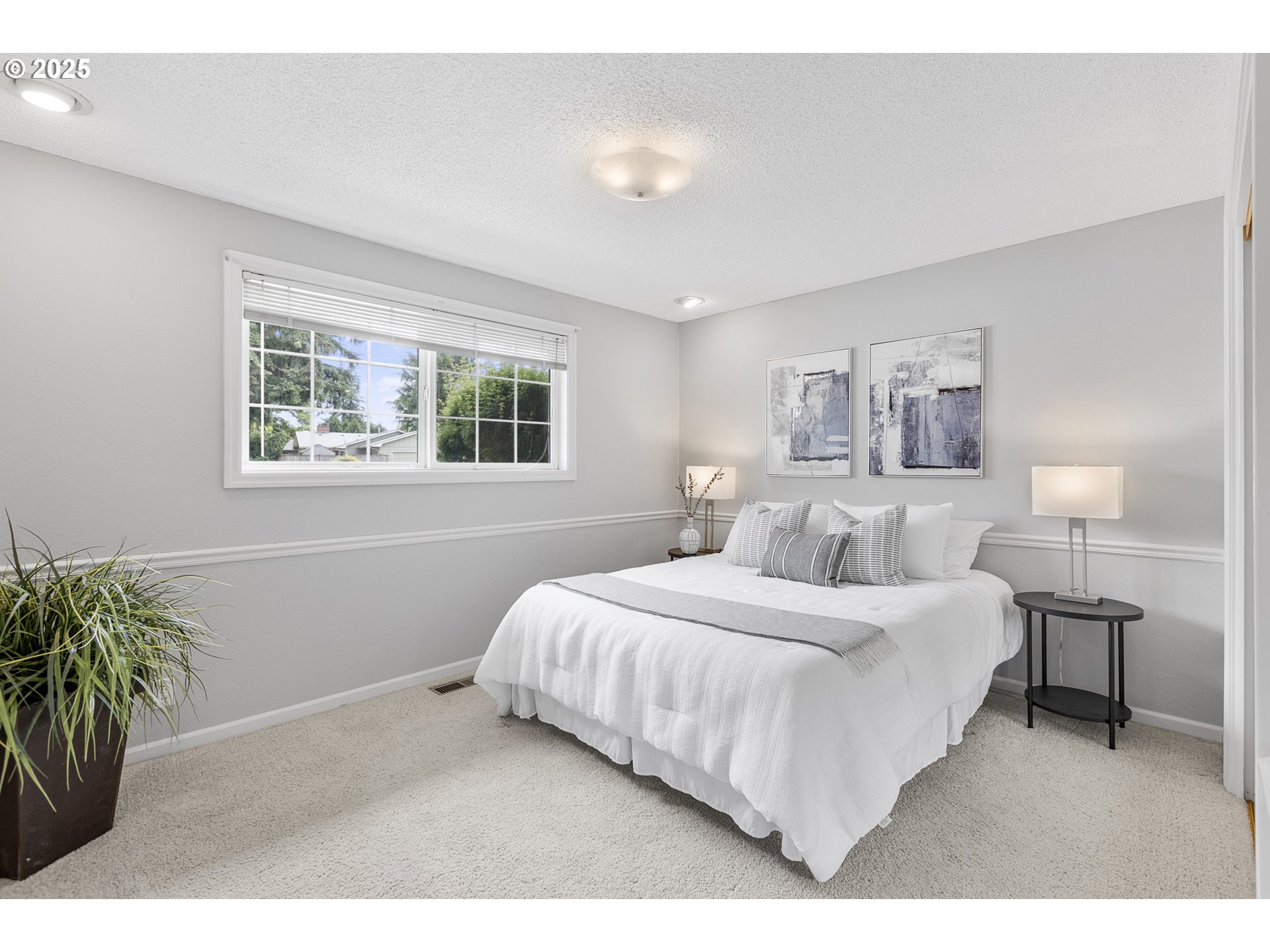 2055 Ridgeway Drive Eugene, OR 97401 - Photo 9 of 48 a bedroom with a bed and a potted plant