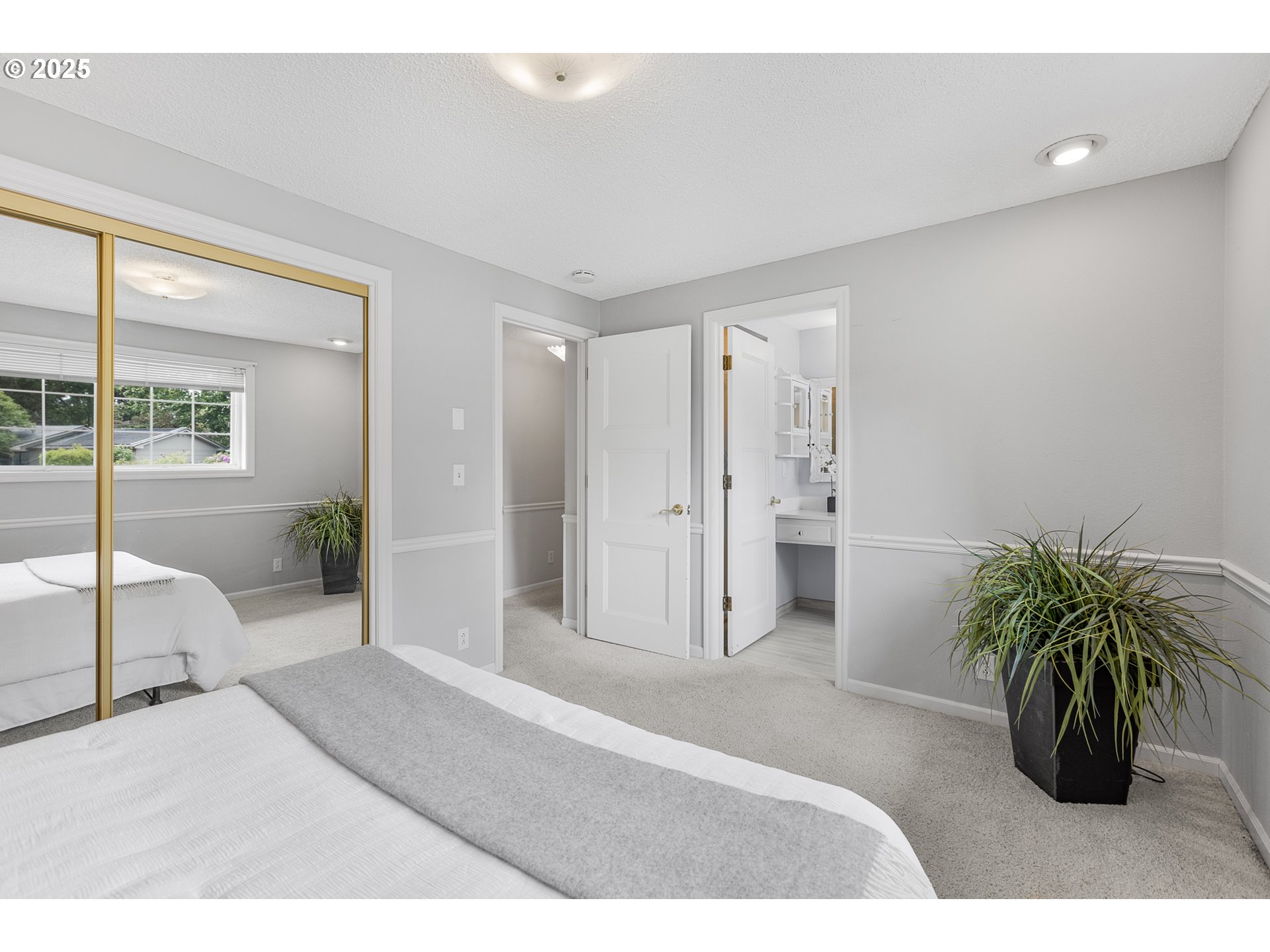 2055 Ridgeway Drive Eugene, OR 97401 - Photo 10 of 48 a bedroom with a bed and a potted plant