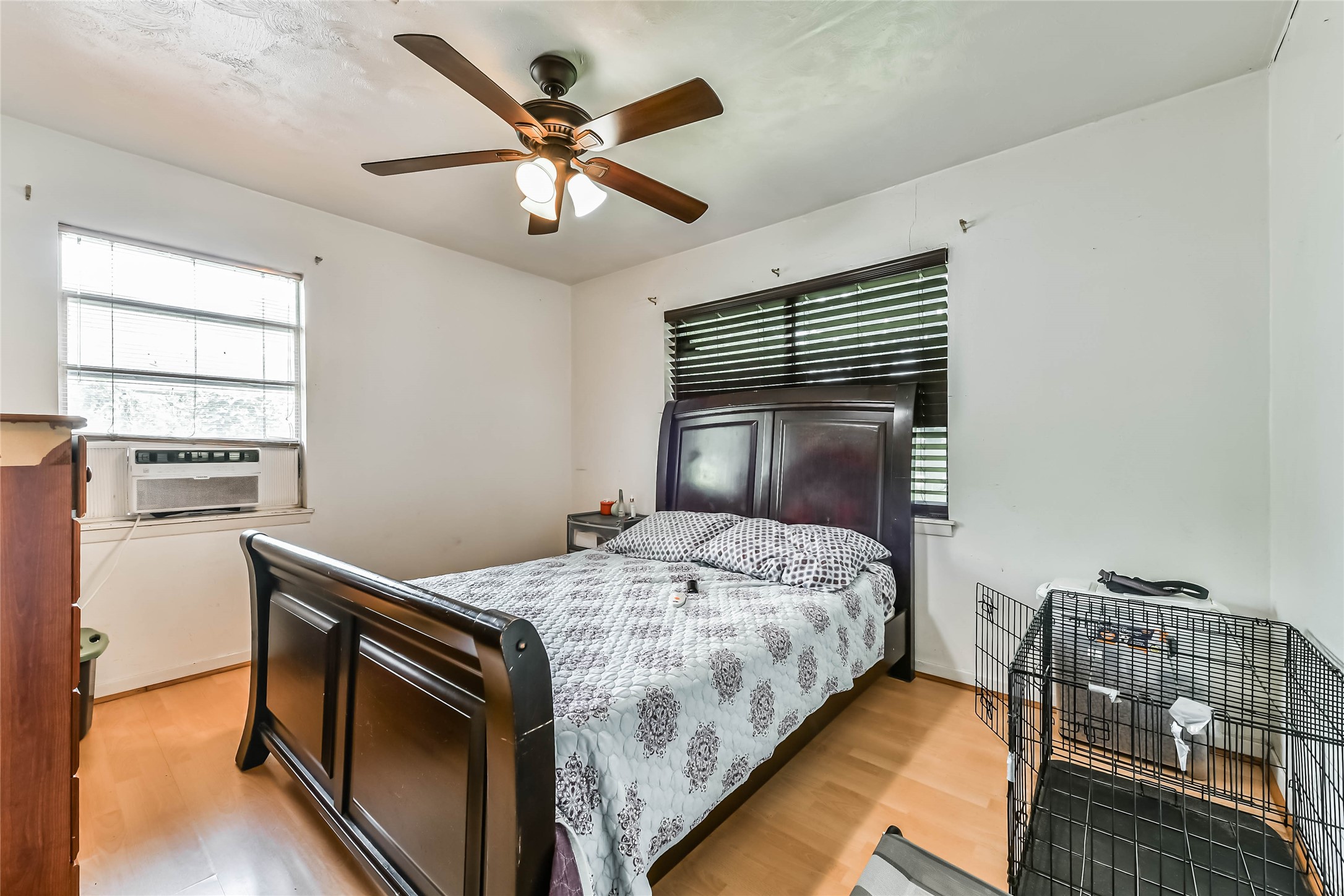 10438 Caxton Street Houston, TX 77016 - Photo 14 of 24 a bedroom with a bed and a chandelier