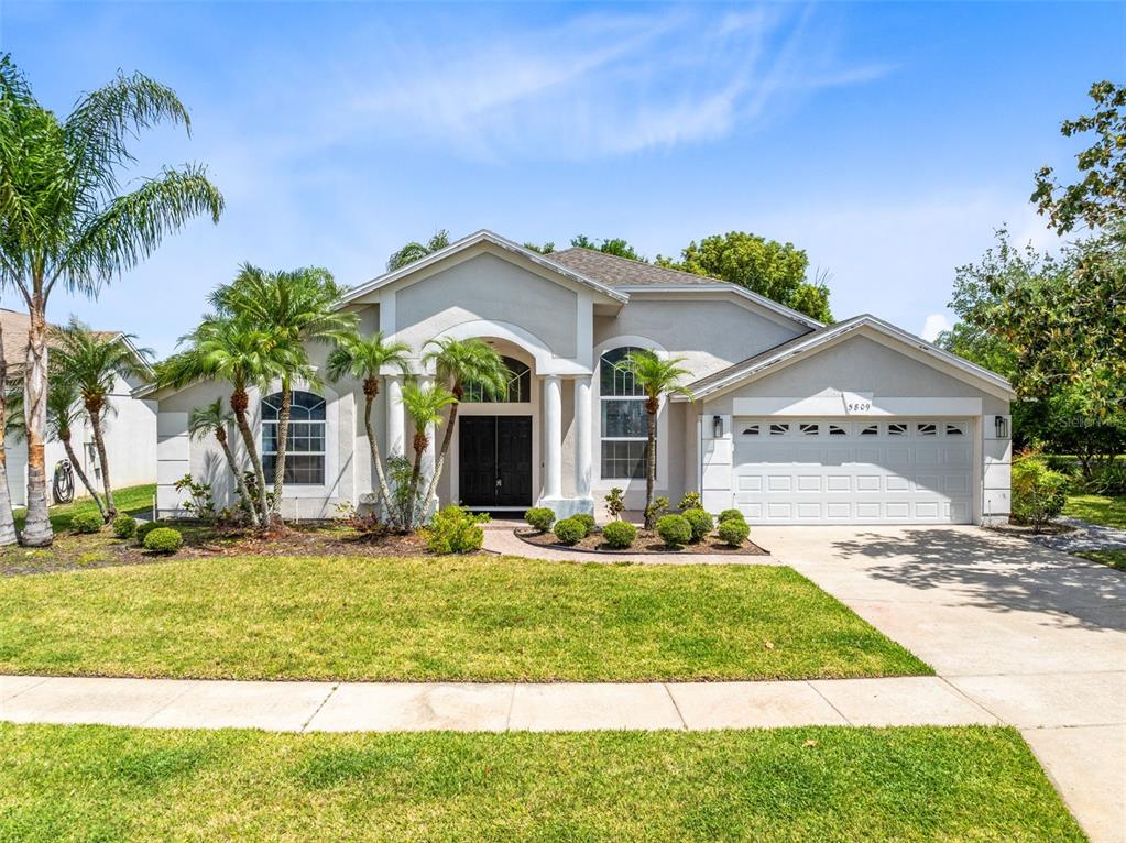 5809 Donnelly Circle Orlando, FL 32821 - Photo 1 of 22 a front view of a house with garden