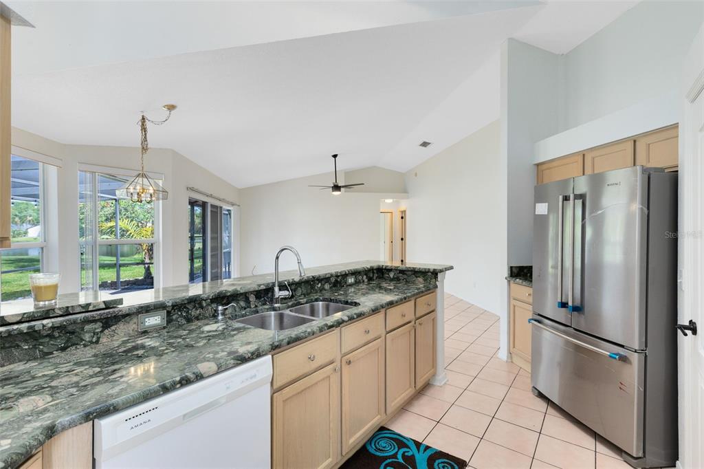 5809 Donnelly Circle Orlando, FL 32821 - Photo 11 of 22 a kitchen with stainless steel appliances granite countertop a sink refrigerator and cabinets