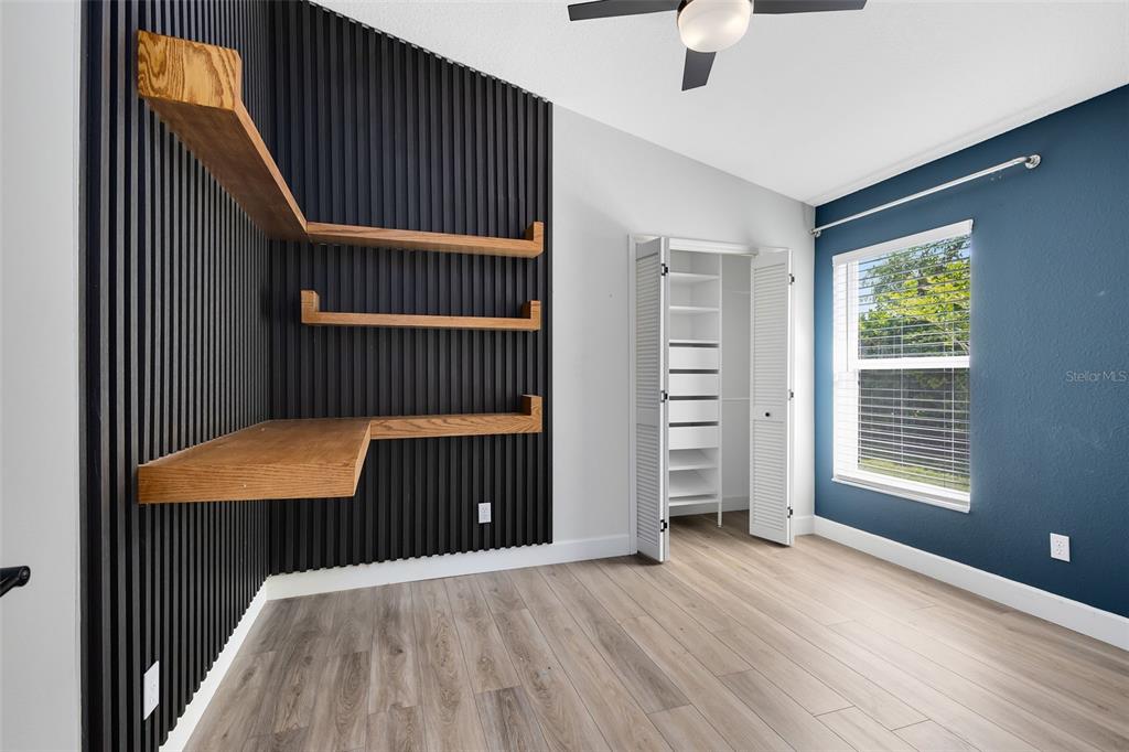 5809 Donnelly Circle Orlando, FL 32821 - Photo 14 of 22 a view of a room with wooden floor windows and a ceiling fan