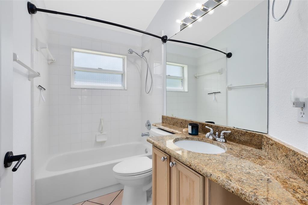 5809 Donnelly Circle Orlando, FL 32821 - Photo 15 of 22 a bathroom with a granite countertop sink toilet and shower